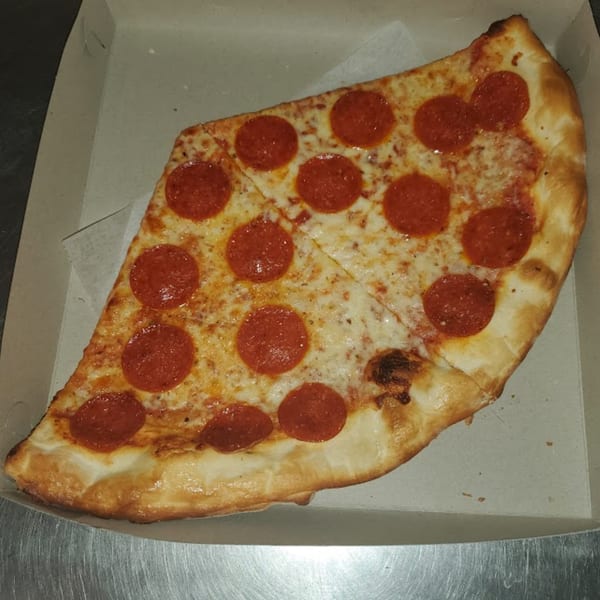 Two slices of pepperoni pizza from Town Center Pizzeria in a cardboard box.