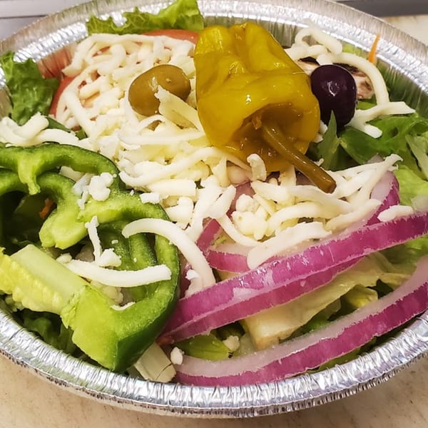 A close-up of a fresh Town Center Pizzeria salad with lettuce, cheese, peppers, onions, and olives.